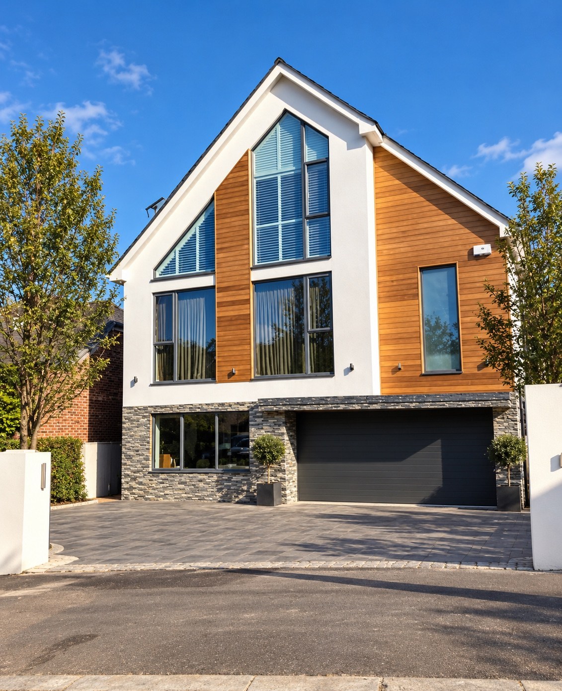 Modern detached house with white render, timber cladding and stone exterior